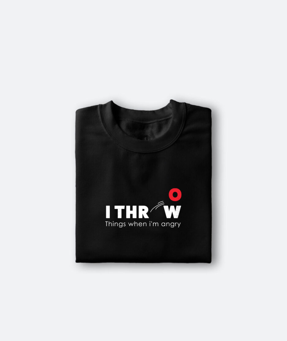 A folded black t-shirt with bold black text that reads "I throw things when I'm angry" against a simple background